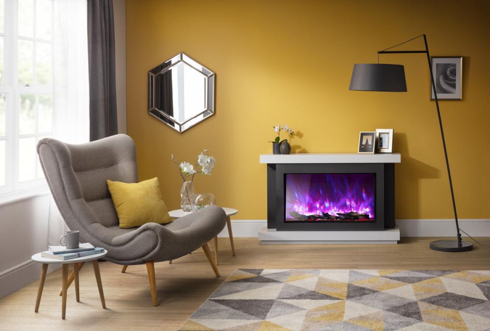 Rayburn Stratus 125-44 XT. Living room with a grey armchair, yellow cushions, and a fireplace with colourful flames.