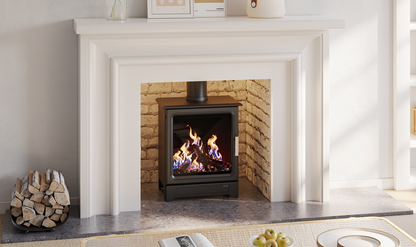 A black gas-burning fireplace insert with a visible flame, set within a white fireplace mantel and brick-lined firebox in a bright interior room.