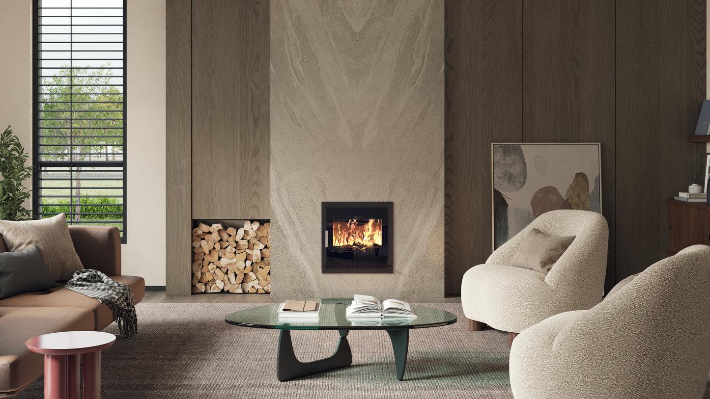 ACR T550 BG. A modern fireplace installed in a tall stone or wood-look wall within a styled living room. The fireplace has a black frame and visible flames.