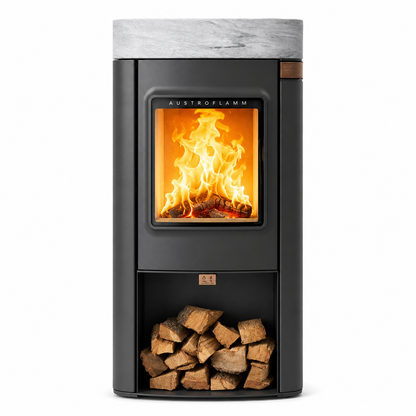 Austrofamm wood-burning stove with a black finish, marble top, open firebox showing flames, and a log storage compartment below, isolated on a white background.