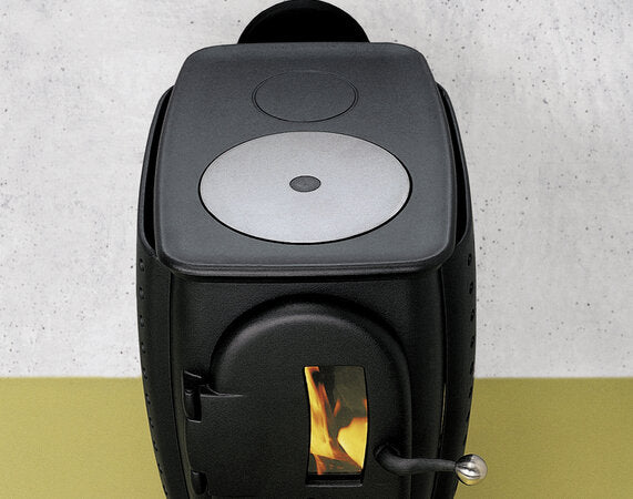 Black stove with visible flame on a light gray background