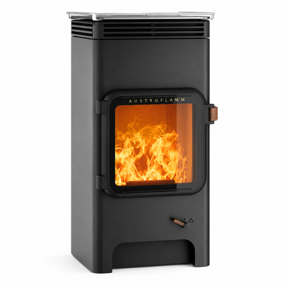 A black Austroflamm wood-burning stove with a glass door showing a bright orange fire inside, set against a plain white background.