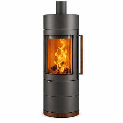 A modern cylindrical wood-burning stove with a dark gray finish, featuring a large glass front window showing a glowing orange fire, with a vertical handle on the side and a small metal chimney pipe extending from the top.