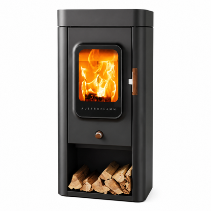 A modern black wood-burning stove with a glass door showing bright orange flames, featuring a lower log storage compartment filled with firewood, on a solid white background.