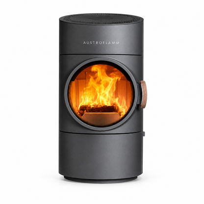 Austroflamm cylindrical wood-burning stove with a dark gray matte finish, featuring a circular glass window showing a bright orange fire inside, on a solid white background.