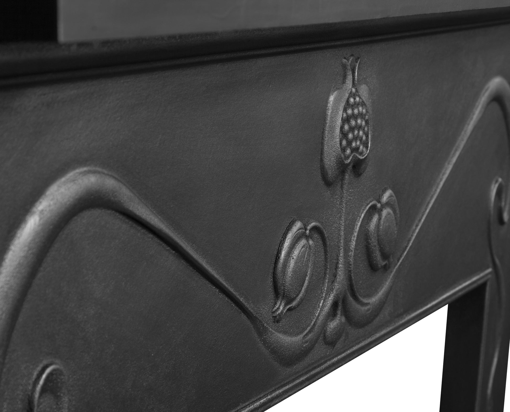 Close-up of a black metal Carron Fireplace with embossed design and logo.