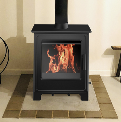 Clifton 4 Black freestanding stove with flames inside, on a tiled floor.