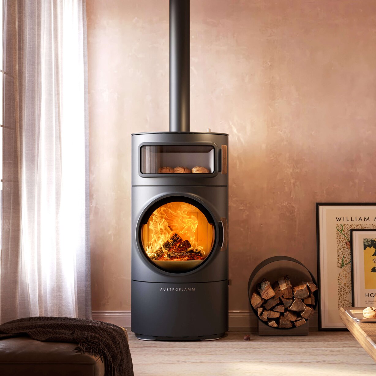 A modern dark gray wood-burning stove with a visible fire inside, set in a warm, rustic room with a textured beige wall, a firewood bucket, and a curtain on the left.
