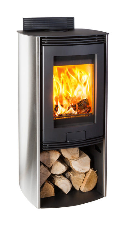 A modern corner wood-burning stove with a stainless steel body, black front door, and visible orange flames, shown on a plain white background with stacked firewood in the lower compartment.