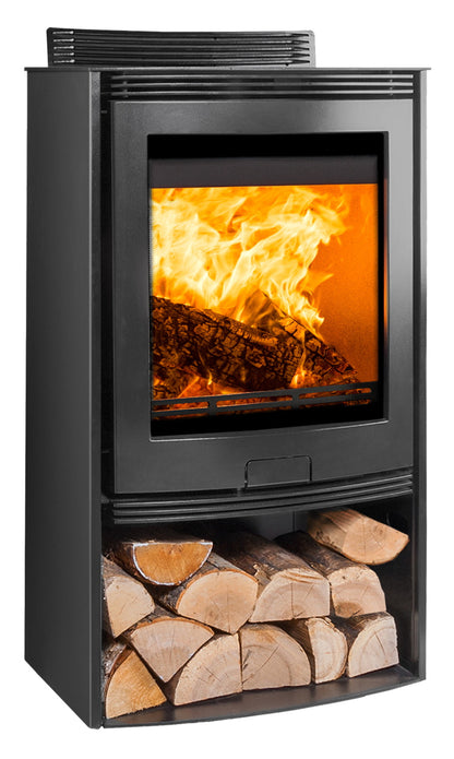 A black freestanding wood-burning fireplace with an open lower shelf holding stacked firewood, shown against a plain white background. The firebox contains visible flames and logs, and a vent grille is visible at the top.