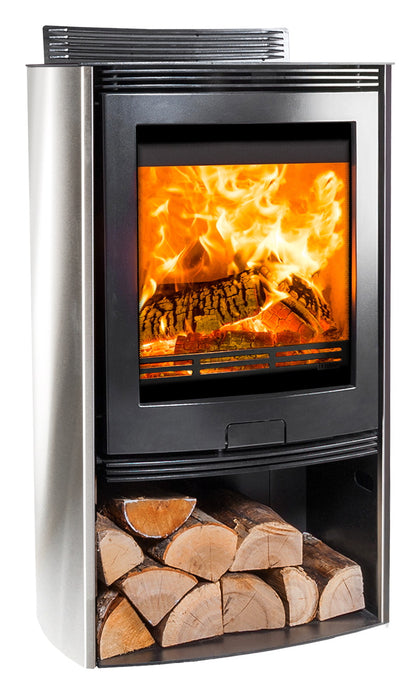 A modern corner fireplace stove with a stainless steel side panel, black front frame, visible wood logs burning in the firebox, and a lower log storage compartment filled with cut firewood, shown on a white background.