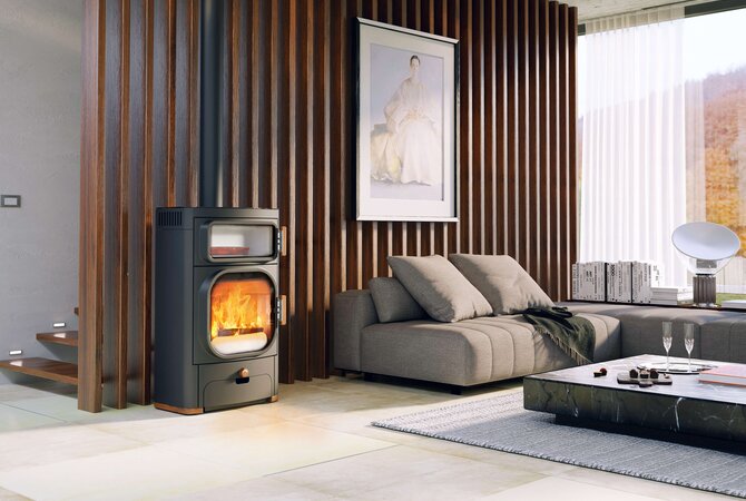 A modern black wood-burning fireplace with a glowing orange fire, set in a contemporary living room with a gray sectional sofa, wooden slat wall, and a coffee table.