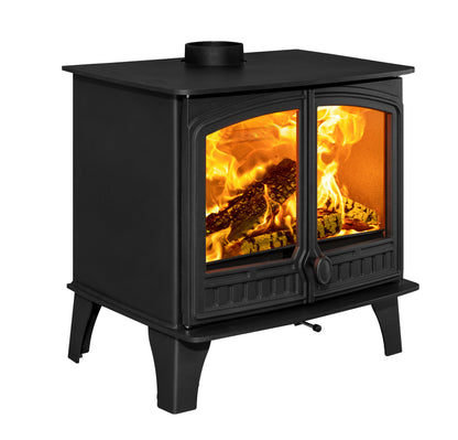 A black cast iron wood-burning stove with two glass doors showing a bright fire inside, isolated on a white background.