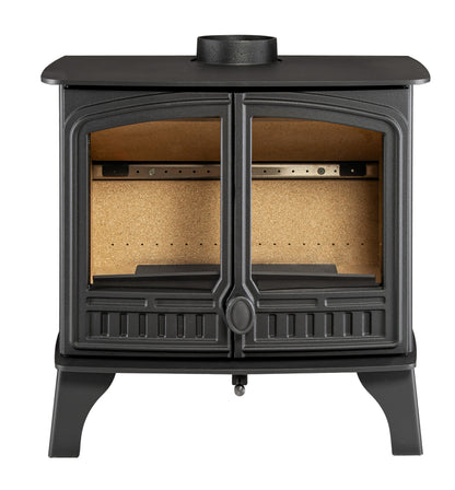 A black cast iron wood-burning stove with two glass-front doors, showing a cork-lined interior, set against a plain white background.