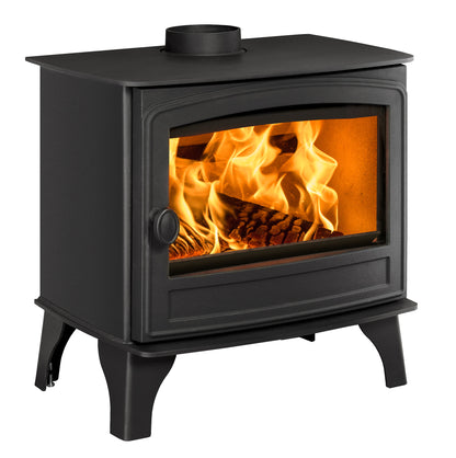 A black cast iron wood-burning stove with a glass front door showing a bright orange fire and logs inside, isolated on a white background.