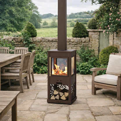 Outdoor patio with a brown metal fire pit, wooden table, and chairs.