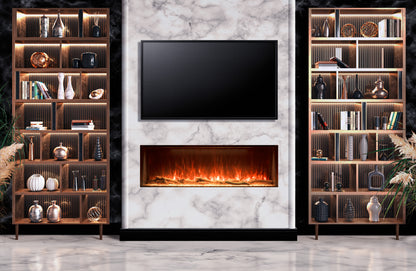 A modern living room setup featuring a rectangular black fireplace insert with glowing orange flames, mounted on a white marble wall. Flanking the fireplace are two tall wooden bookshelves with warm LED lighting and decorative objects.