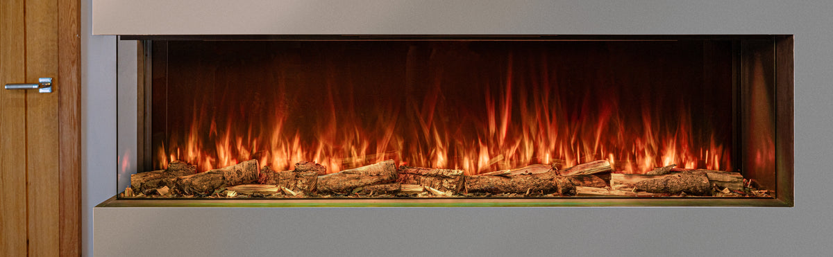 A modern linear electric fireplace insert with realistic orange and yellow flames rising over faux logs, set into a light gray wall next to a wooden door.