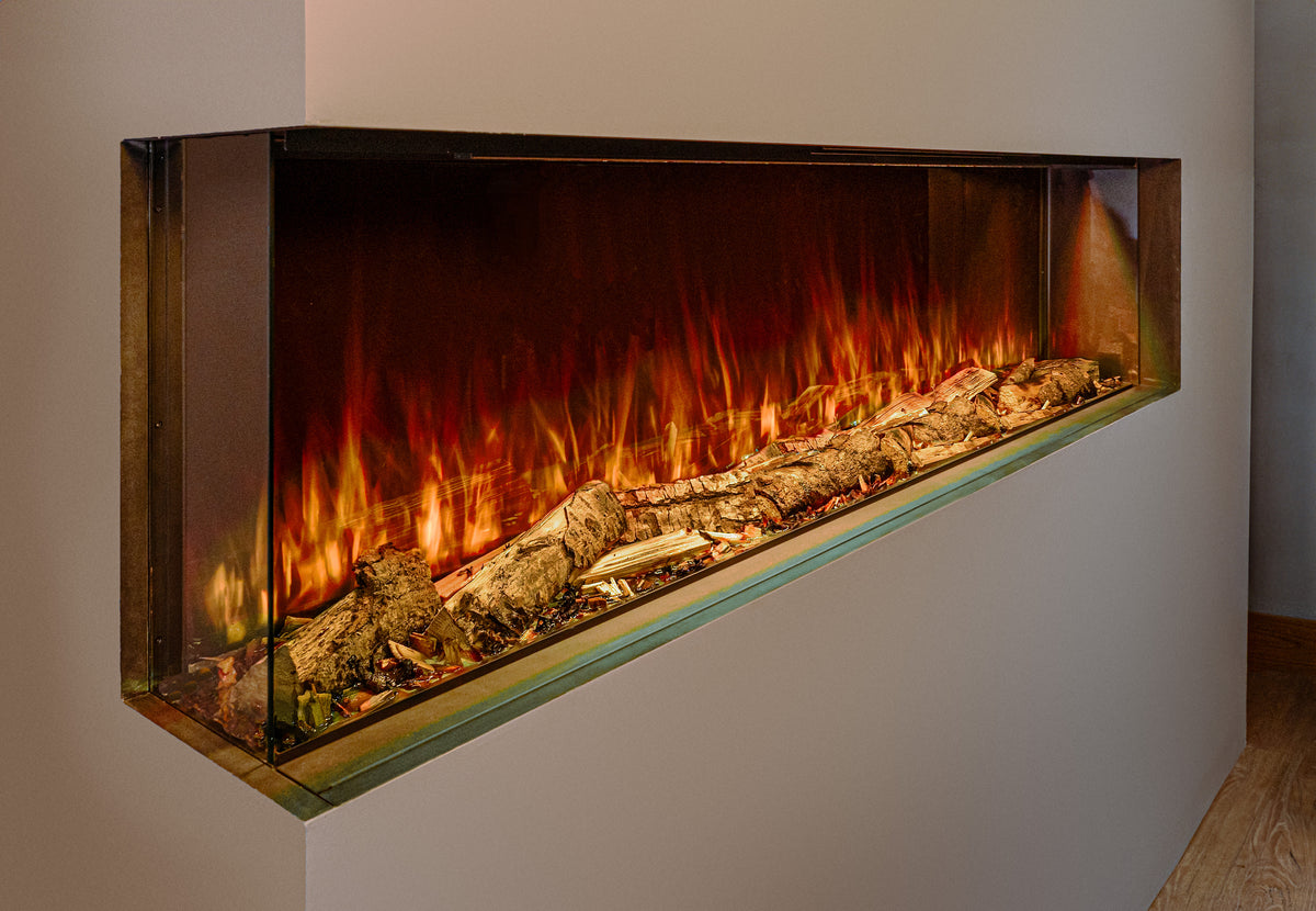 A modern linear electric fireplace insert mounted on a light beige wall, featuring realistic orange and yellow flames, glowing embers, and decorative logs inside a sleek rectangular glass frame.