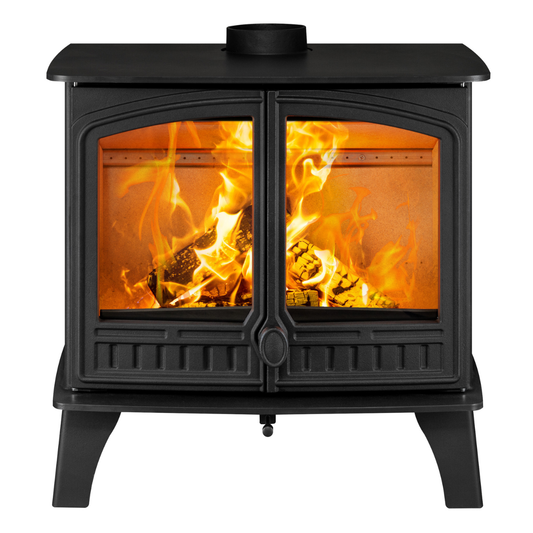A black cast iron wood-burning stove with two glass doors showing a bright orange and yellow fire inside, isolated on a white background.