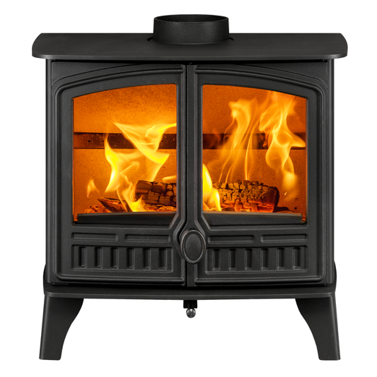 A black cast iron wood-burning stove with two glass doors showing bright orange flames and logs inside, isolated on a white background.