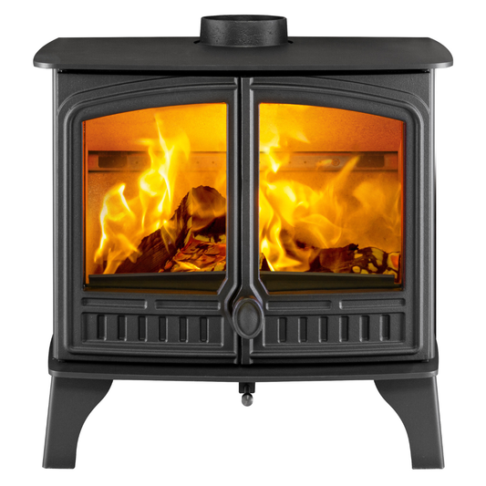 A black cast iron wood-burning stove with two glass doors showing bright orange and yellow flames, set against a solid white background.