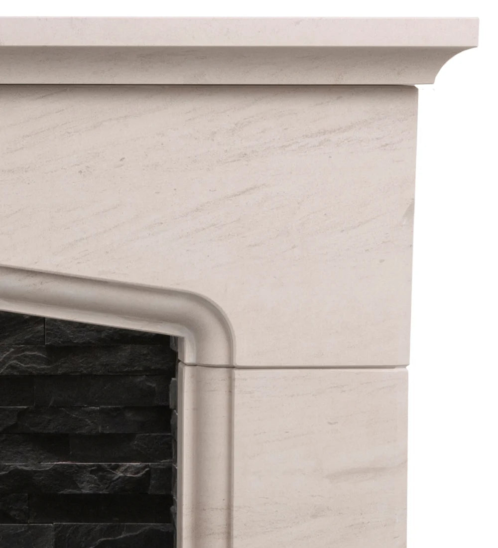 Close-up of a cream-colored limestone fireplace mantel and surround with a black stacked stone insert visible on the left.