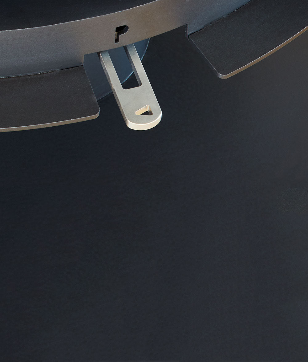 Close-up of a metal bracket on a dark surface