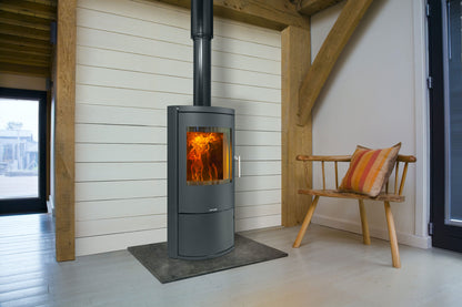 Opus Harmony Wood-burning stove in a modern room with wooden beams and a bench.