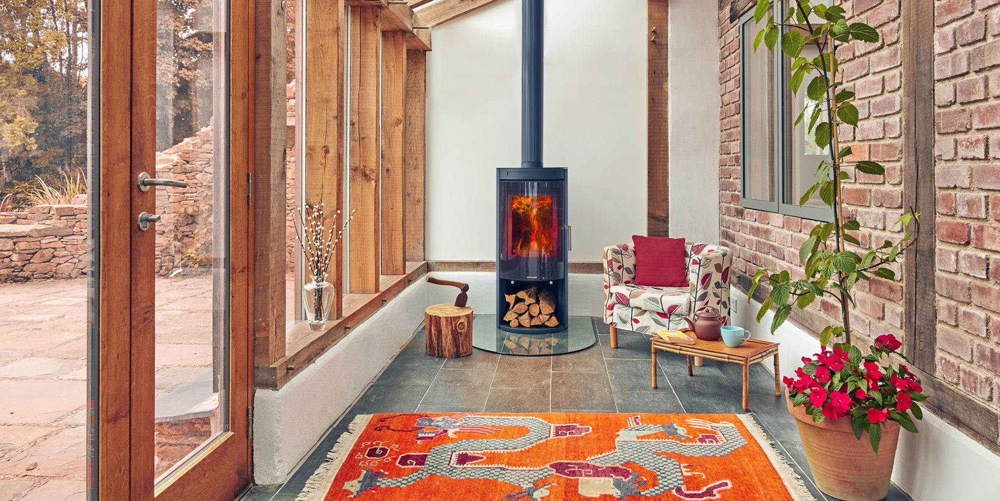 Opus Melody Stove by a colorful rug, and decorative elements.