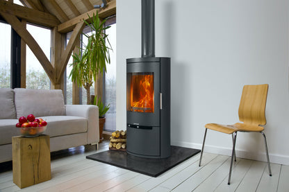 Opus Wood-burning stove in a modern living room with a sofa, chair, and decorative items.