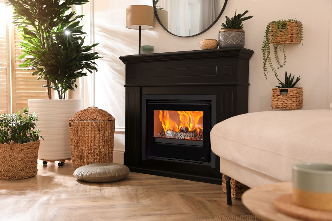 Living room with a black Opus Octave fireplace, plants, and a white sofa.