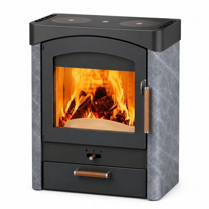 A modern wood-burning stove with a black metal body, gray textured side panels, copper-toned drawer handles, and a glass front showing a glowing fire inside.