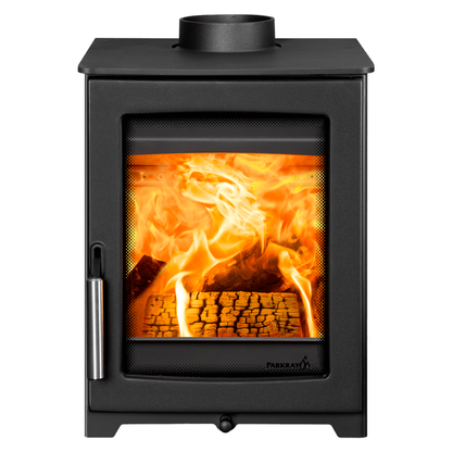 A black Pureshape wood-burning stove with a glass front door showing a glowing orange fire and logs inside, isolated on a white background.