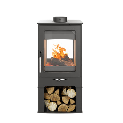 A black wood-burning stove with a glass front door showing a fire inside, a silver handle, and a lower storage compartment filled with cut logs, isolated on a white background.