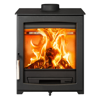 A black wood-burning stove with a glass front door showing bright orange and yellow flames over logs, photographed against a plain white background.