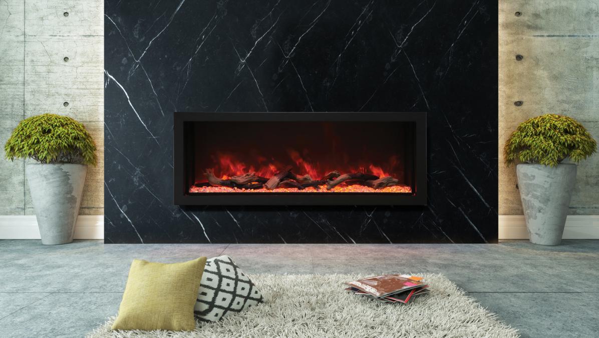 Rayburn Stratus 100-44 XT. Modern electric fireplace embedded in a black marble wall with decorative elements.