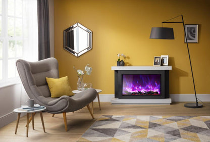Rayburn Stratus 125-44 XT. Living room with a grey armchair, yellow cushions, and a fireplace with colourful flames.