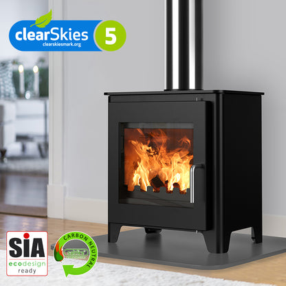 Saltfire ST1 Black wood stove with visible flames, branded with clearSkies and SIA logos, in a room setting.