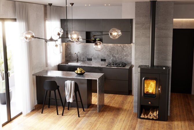A modern kitchen interior with dark gray cabinets, a stone countertop island, black bar stools, pendant lights, wood flooring, and a black wood-burning stove with a visible fire.
