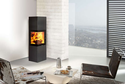 Modern living room with a wood-burning stove, chairs, and a table.