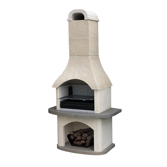 A freestanding outdoor stone barbecue grill with a chimney and lower firebox, set in a patio garden with plants, a dining table, and seating visible.