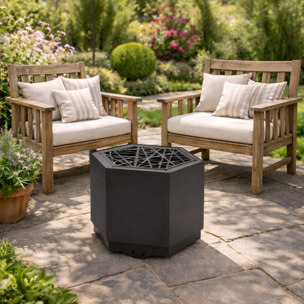Hexagonal fire pit on a patio with wooden chairs and cushions in a garden setting.