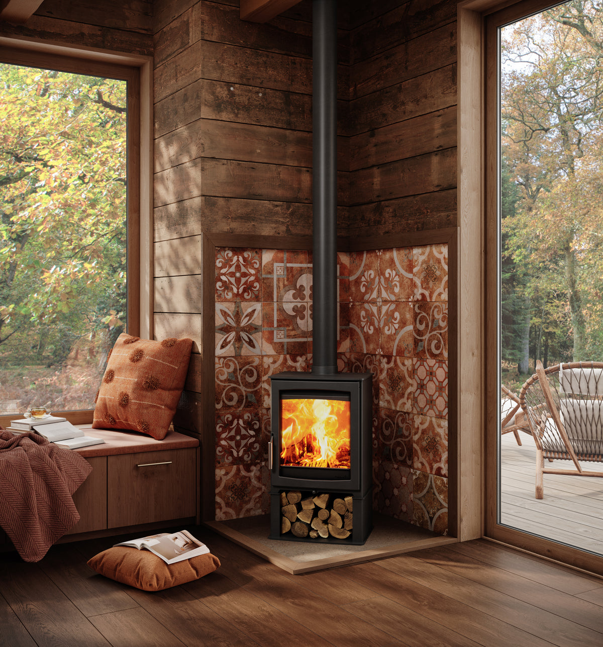 Wood-burning stove in a cozy room with wooden walls and large windows showing trees outside.